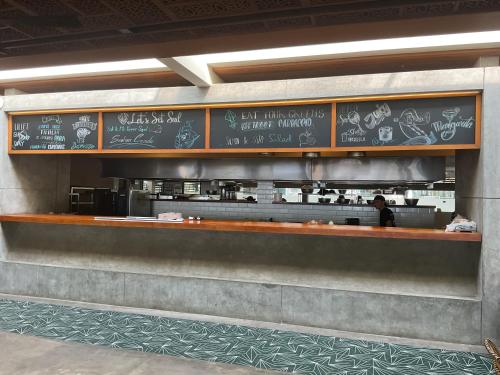 a restaurant with a counter with chalk drawings on it at Green Inn Phu Quoc Hotel in Phu Quoc