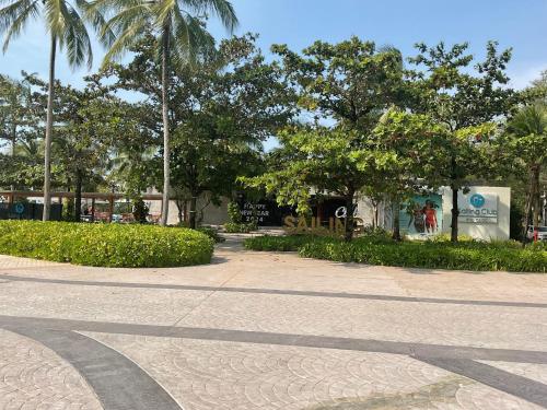 a street with palm trees and a sidewalk at Green Inn Phu Quoc Hotel in Phu Quoc