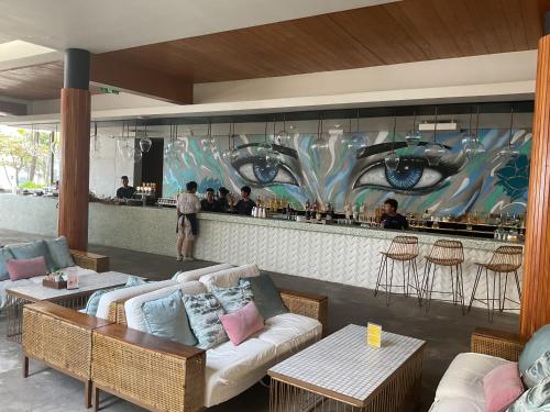 a restaurant with a couch and a bar at Green Inn Phu Quoc Hotel in Phu Quoc