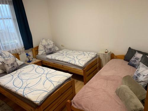 a room with three beds and a window at Urlaub am Bauernhof Familie Rößler vlg. Spor in Pöls