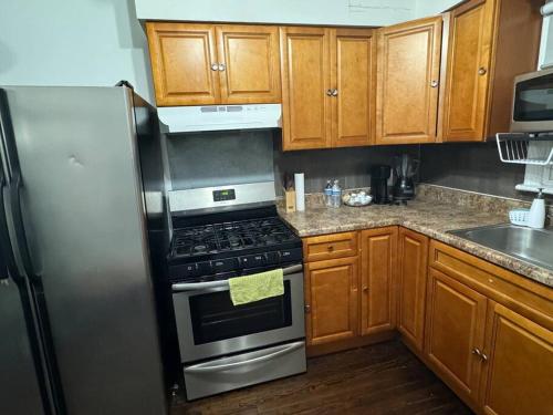 a kitchen with a stove and a refrigerator at NYC Gateway: Cozy Home with Easy Access in Passaic