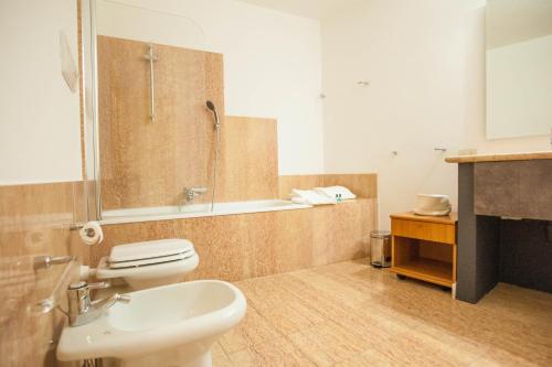 a bathroom with a toilet and a shower and a sink at Italianflat - Via Mazzini in Verona