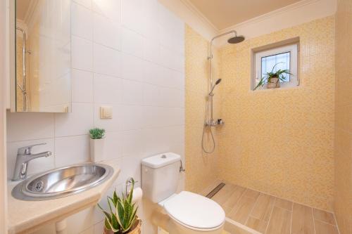 a bathroom with a toilet and a sink at Τ&G Home in Corfu Town