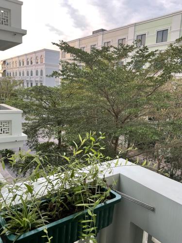 a balcony with plants and buildings in the background at Green Inn Phu Quoc Hotel in Phu Quoc