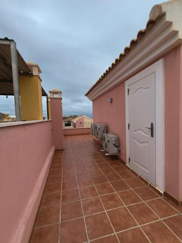 a balcony with a door on a house at Casa Trastévere in San Juan de los Terreros