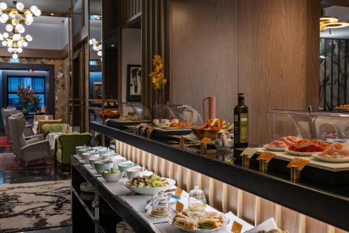 a buffet line with plates of food on display at Umiltà 36 in Rome