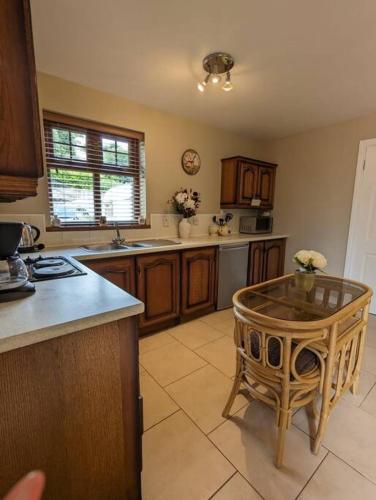 a kitchen with a table in the middle of it at TeachinTom in Strabane