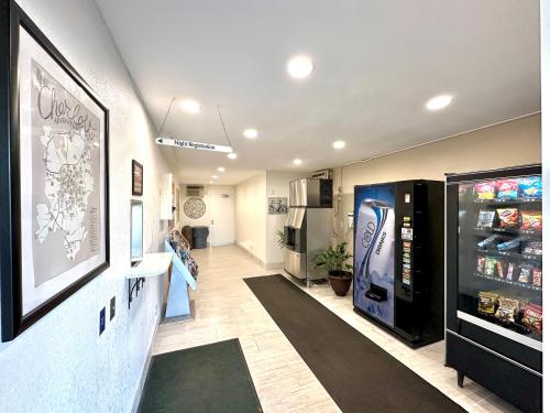 a room with a drink refrigerator in a store at Royal Inn and Suites Charlotte Airport in Charlotte
