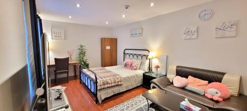 a living room with a couch and a bed at Mainfloor Spacious Room in Toronto in Toronto