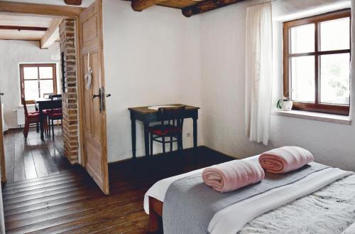 a bedroom with a bed with two pillows on it at Lavendowo in Piechowice
