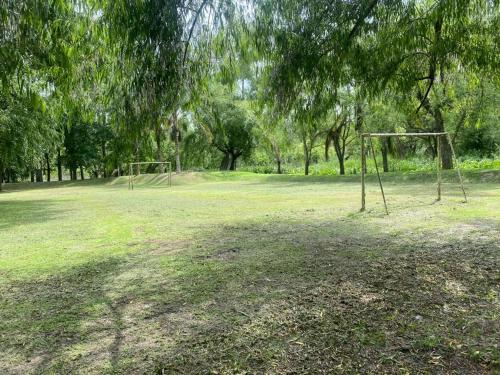 an open field with a soccer goal in a park at Cabañas El Tercer Ojo Tigre in Tigre
