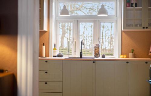 a kitchen with a sink and a window at Nice Home In Bredebro With Wifi in Bredebro