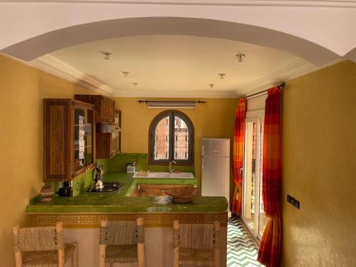 a kitchen with an archway in the middle of it at The Rainbow House in Mirleft