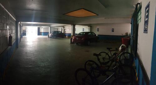 an empty garage with two cars parked in it at Nuestras Raíces Hotel - Museo - Restaurante in San Cristóbal de Las Casas