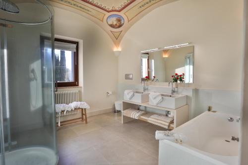 a bathroom with a shower and two sinks and a tub at Pietra Campana Italian Villa Orvieto in Orvieto