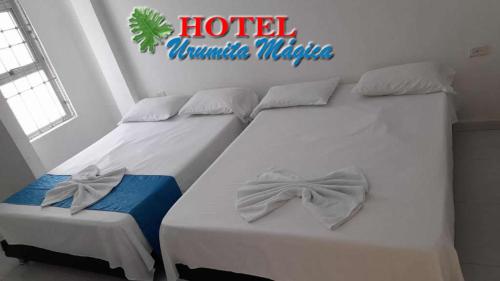 Tempat tidur dalam kamar di Hotel URUMITA MAGICA