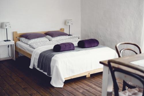 a bedroom with two beds with purple pillows on them at Lavendowo in Piechowice