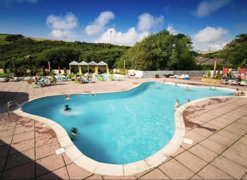 a large swimming pool with people in the water at Newquay Bay Resort Sandy Toes - Hosting up to 6 in Newquay