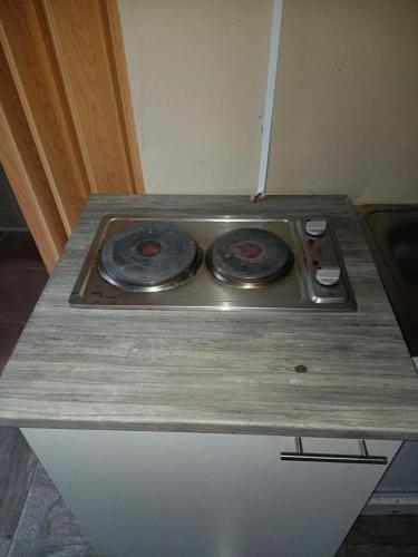 a stove top sitting on top of a counter at wandile's family dining place in Johannesburg