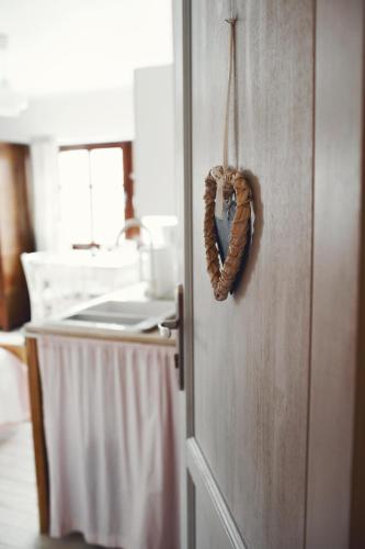 a wicker heart hanging on a door in a kitchen at Lavendowo in Piechowice