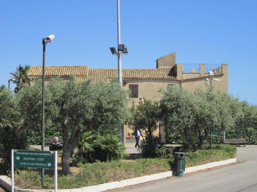 a building with trees and a sign in front of it at VistaMare in Realmonte