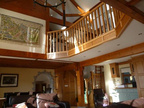 a living room with a staircase in a house at Crotlieve Barn in Rostrevor