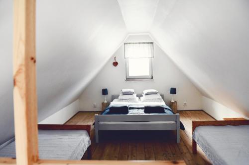 a attic bedroom with two beds and a window at Lavendowo in Piechowice