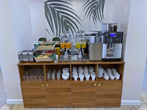 a wooden shelf with cups and a coffee maker at FERNWEH No 5 Boutique Hotel MAMAIA Nord in Mamaia Sat/Năvodari