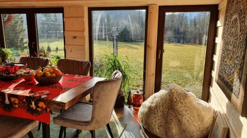 a dining room with a table with a bowl of fruit at Wellness-Beskydy in Prostřední Bečva