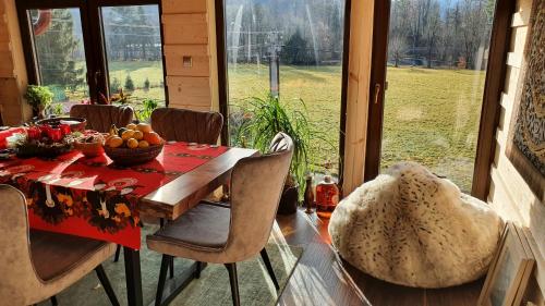 a dining room with a table with a bowl of fruit at Wellness-Beskydy in Prostřední Bečva