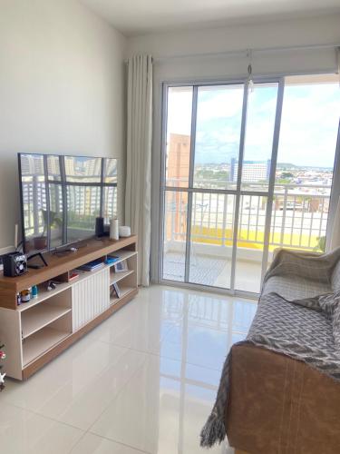 a bedroom with a bed and a large window at Quarto Privado in Aracaju