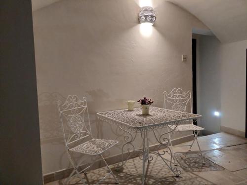 a table with two chairs and a table with two cups at Sacratum B&B Suite Spa in Mesagne