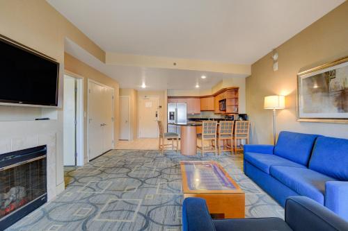 a living room with a blue couch and a fireplace at Luxury 1BD/1BTH Suite at Platinum Hotel *STRIP VIEW in Las Vegas