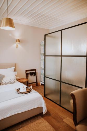 a bedroom with a bed and a sliding glass door at Perlacia Hotel Adatepe in Adatepe