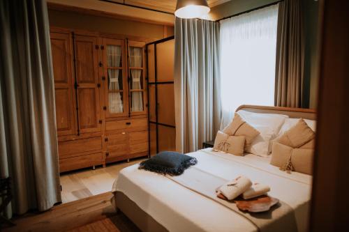 a bedroom with a bed with towels on it at Perlacia Hotel Adatepe in Adatepe