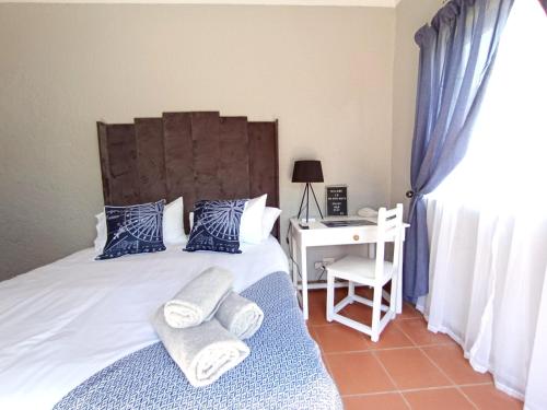 a bedroom with a bed with towels on it at OR Tambo Stay Unit 2 in Boksburg