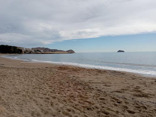 a sandy beach with a view of the ocean at Casa Trastévere in San Juan de los Terreros