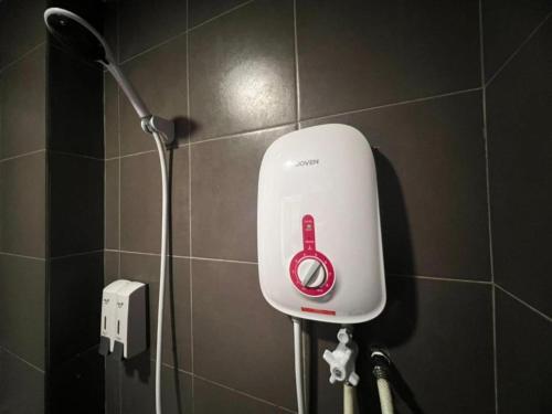 a red and white hair dryer in a bathroom at Seeds Hotel Cheras Maluri in Kuala Lumpur