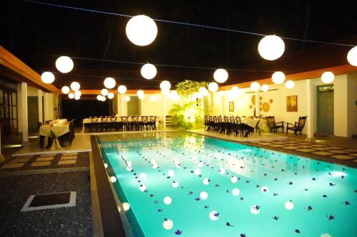 a large swimming pool with white balls in it at Villa Blue Lotus Katunayake in Katunayake