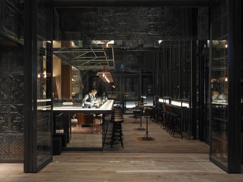 a room with a person sitting at a table at Hotel Proverbs Taipei in Taipei
