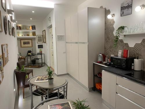 a kitchen with a table and a white refrigerator at Ecclesia Domus Vatican Inn in Rome