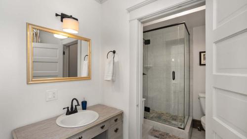 a bathroom with a sink and a mirror and a shower at Greenbriar Inn in Coeur d'Alene