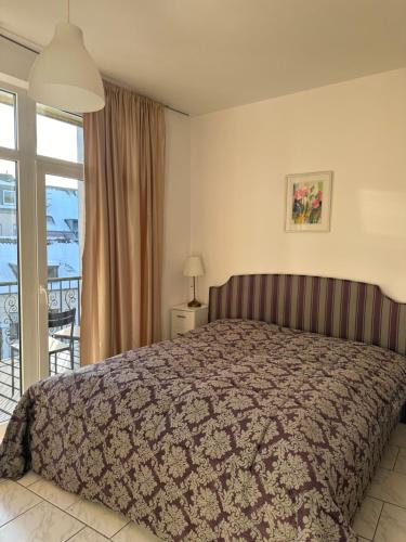 a bedroom with a bed and a balcony at City-Wohnung 2 in Brühl