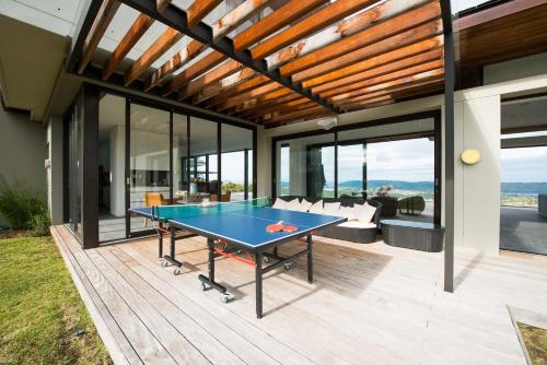 a ping pong table in the middle of a house at Collection Luxury Accomodation Simola House in Knysna