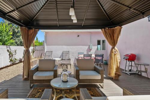 an outdoor patio with chairs and a table at Lovely North Hollywood House Near Universal in North Hollywood