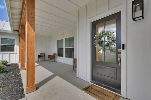a front door of a white house with a porch at The Modern Farmhouse in Yuba City