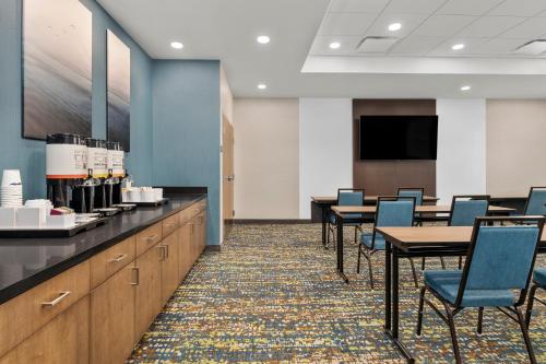 a conference room with tables and chairs and a tv at Hampton Inn By Hilton Cornwall in Cornwall
