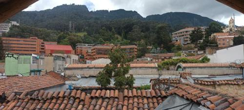 a view of a city with buildings and mountains at Villa Monserrate Bed and Breakfast in Bogotá