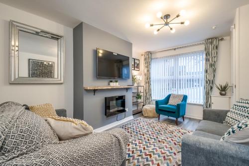 a living room with a couch and a fireplace at Walk to City Centre Townhouse, Garden and Parking by StayByNumbers in Belfast