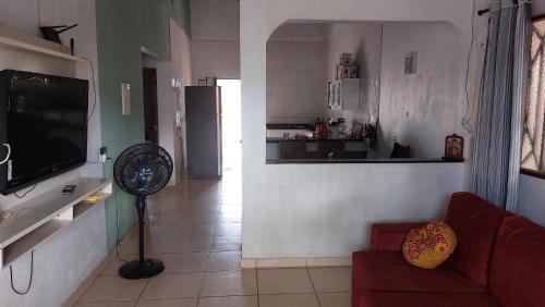a living room with a couch and a kitchen at Start in Boa Vista